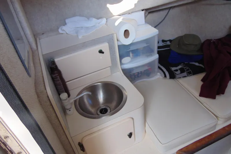 Slide: The Image of 2004 Parker Walkaround boat interior with sink, storage, and seating area. - 15
