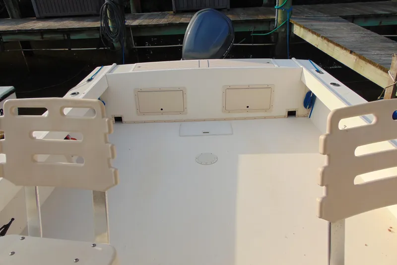 Slide: The Image of 2004 Parker Walkaround boat deck with seating and storage compartments. - 17