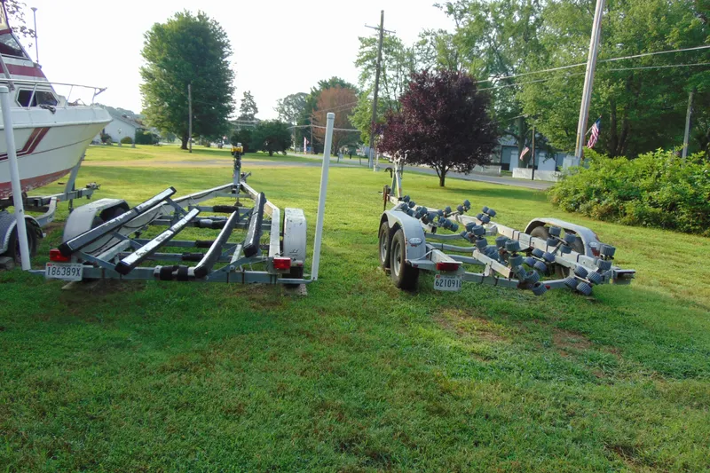 Slide: The Image of Two boat trailers on grass near a Parker Walkaround 2004. - 18