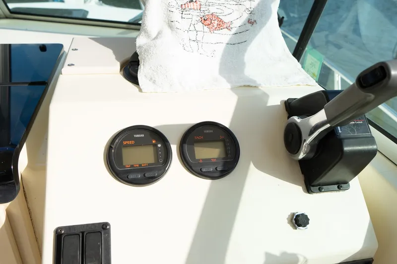 Slide: The Image of 2004 Parker Walkaround boat dashboard with Yamaha speed and tachometer gauges. - 33