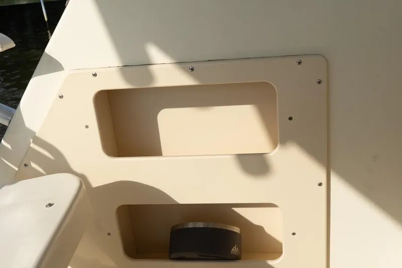 Slide: The Image of 2004 Parker Walkaround boat interior with storage compartments and speaker. - 34