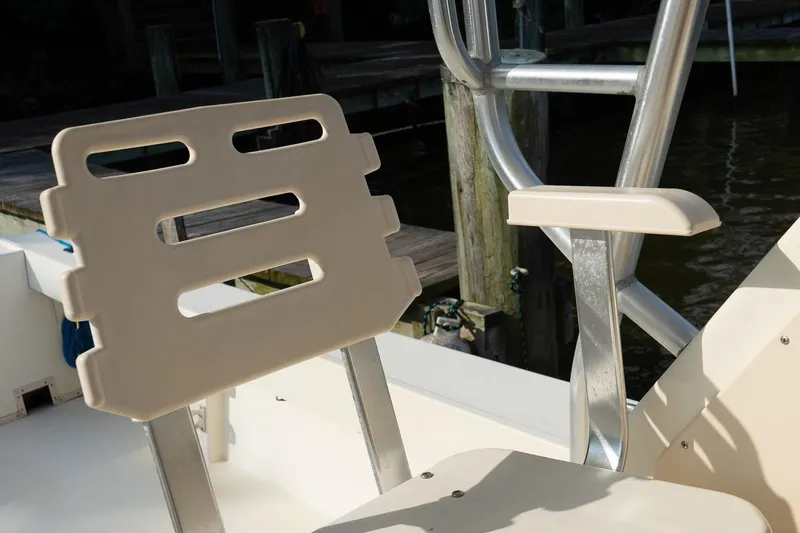 Slide: The Image of 2004 Parker Walkaround boat seat with armrest, dockside view. - 35