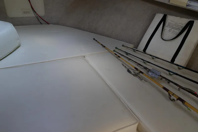 Slide: The Image of 2004 Parker Walkaround cabin interior with fishing rods and life jacket. - 39