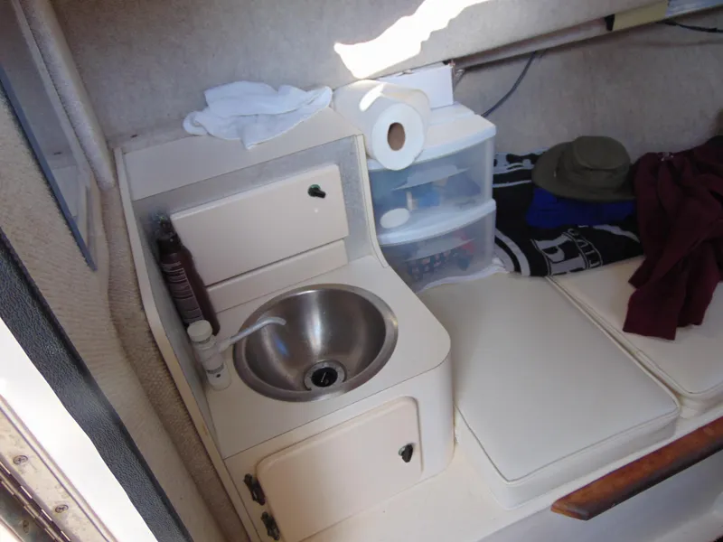 Slide: The Image of 2004 Parker Walkaround boat interior with sink, storage, and seating area. - 7