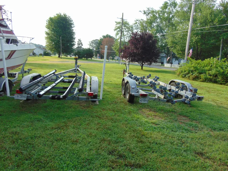 Slide: The Image of Two boat trailers on grass beside a Parker Walkaround, 2004 model. - 9