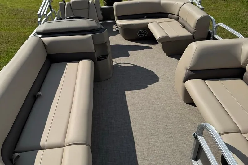 Slide: The Image of 2025 Sun Tracker Party Barge 18 DLX interior with beige seating and spacious layout. - 6