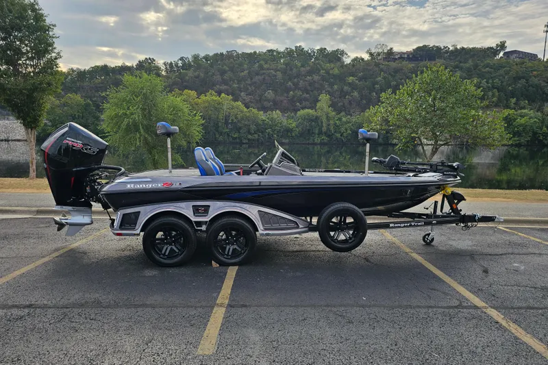 The Image of 2025 Ranger Z519R Cup-Equipped boat parked by a scenic lake. - 0