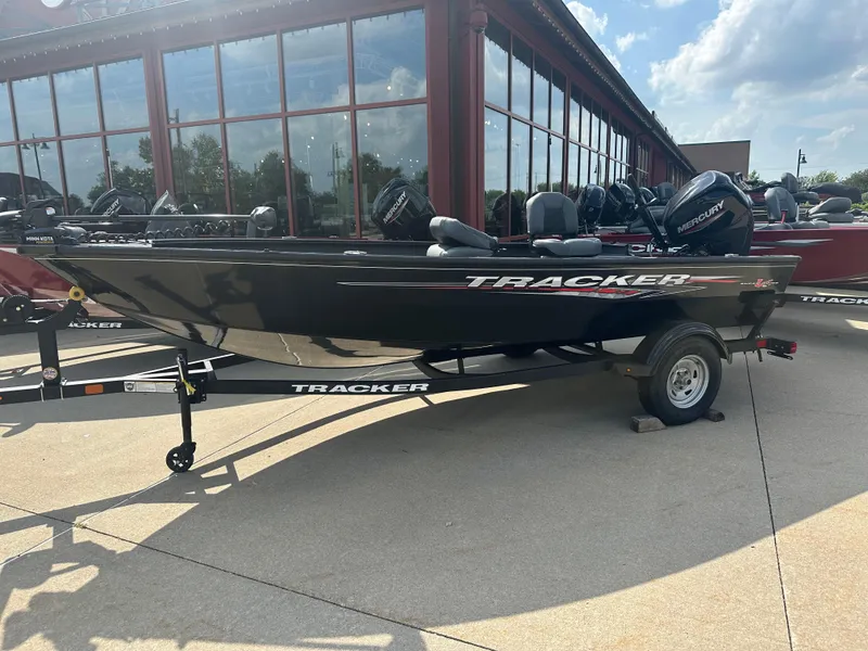 The Image of 2025 Tracker Super Guide V-16 T boat on trailer, parked outdoors. - 0