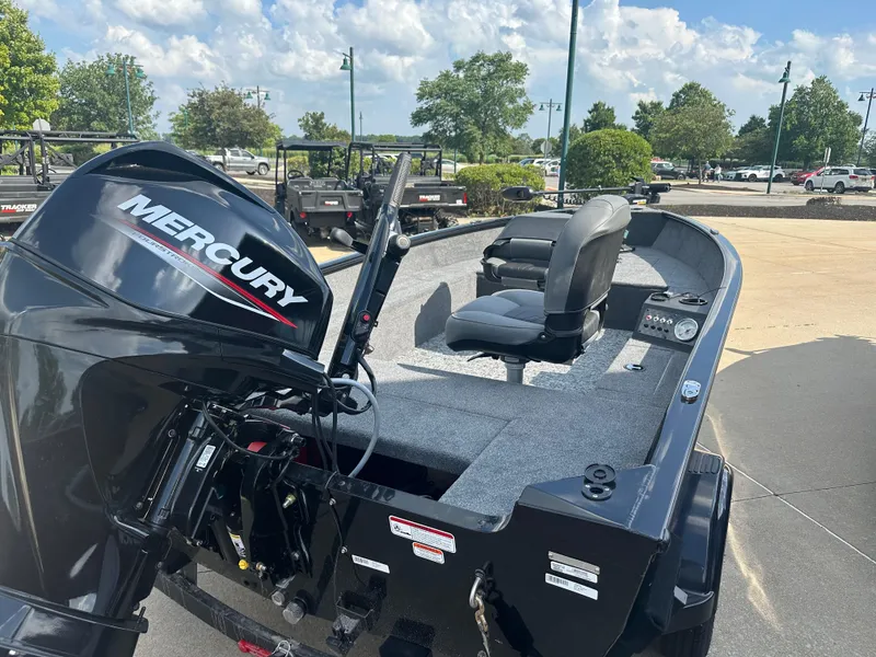 Slide: The Image of 2025 Tracker Super Guide V-16 T boat with Mercury engine, parked outdoors. - 3