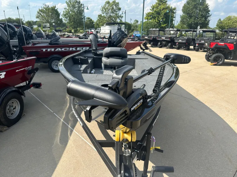 Slide: The Image of 2025 Tracker Super Guide V-16 T boat with Minn Kota motor in outdoor showroom. - 4