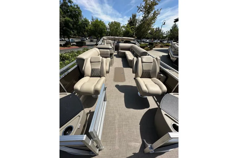 Slide: The Image of 2025 Sun Tracker Sportfish 24 XP3 pontoon boat with spacious seating and modern design. - 2