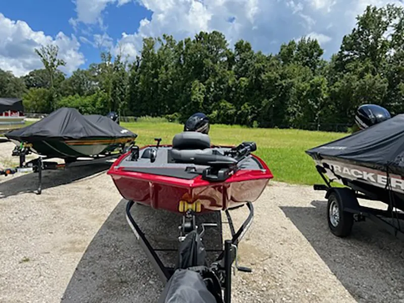Slide: The Image of 2025 Tracker Panfish 17 boat on trailer, parked outdoors under a cloudy sky. - 2