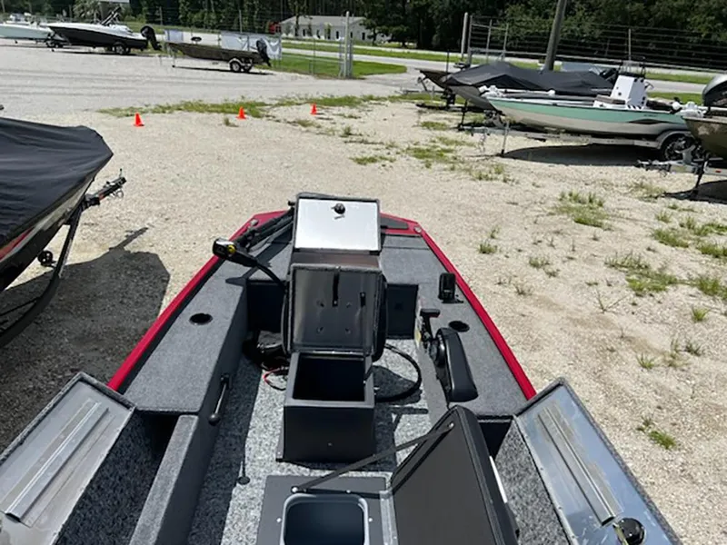 Slide: The Image of 2025 Tracker Panfish 17 boat interior with storage compartments, parked outdoors. - 5