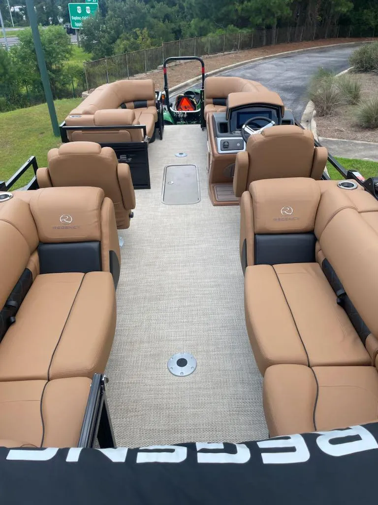 Slide: The Image of 2025 Regency 230 LE3 pontoon boat with luxurious tan seating and modern design. - 4
