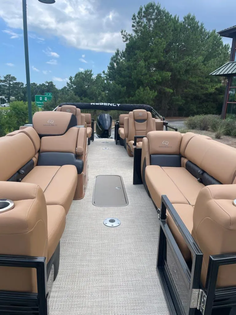 Slide: The Image of 2025 Regency 230 LE3 pontoon boat with luxurious tan seating and spacious layout. - 5
