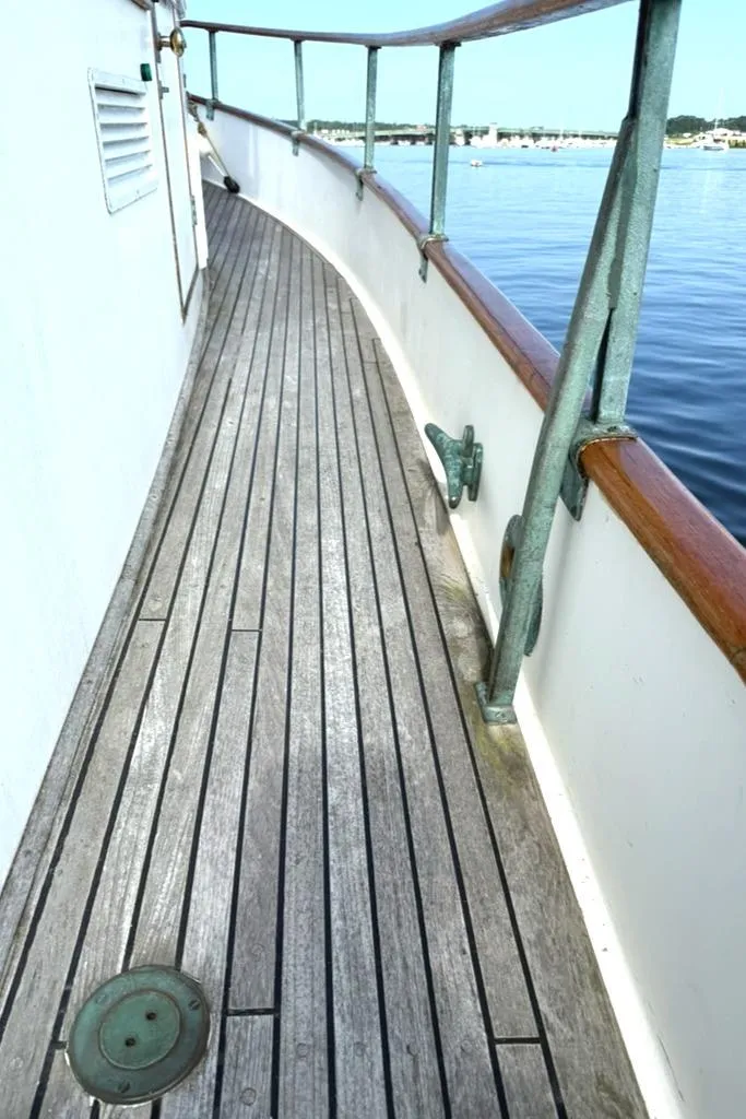 Slide: The Image of 1981 Grand Banks 36 Classic yacht deck with wooden flooring and metal railings. - 13