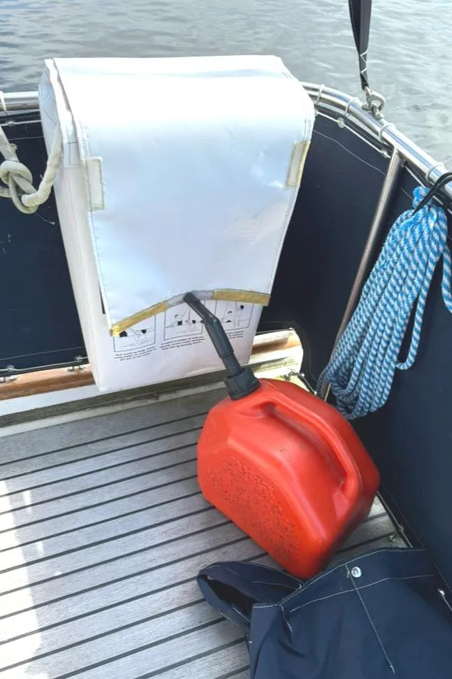 Slide: The Image of Red fuel container on 1981 Grand Banks 36 Classic boat deck with rope and cover. - 14