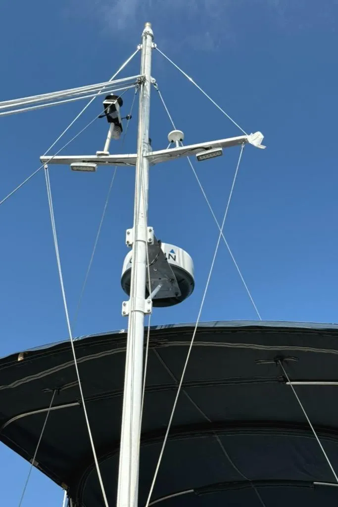 Slide: The Image of Mast of 1981 Grand Banks 36 Classic boat against clear blue sky. - 16