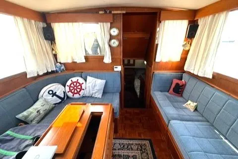 Slide: The Image of Interior of 1981 Grand Banks 36 Classic yacht with blue seating and nautical decor. - 17