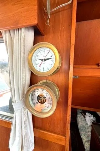 Slide: The Image of Brass clock and barometer on 1981 Grand Banks 36 Classic wooden interior. - 20