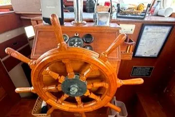 Slide: The Image of Wooden helm of 1981 Grand Banks 36 Classic boat with nautical instruments. - 21