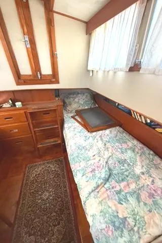 Slide: The Image of Cozy cabin interior of 1981 Grand Banks 36 Classic with bed and wooden furnishings. - 23