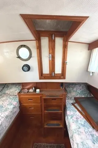 Slide: The Image of Interior of 1981 Grand Banks 36 Classic with wooden cabinetry and twin beds. - 24