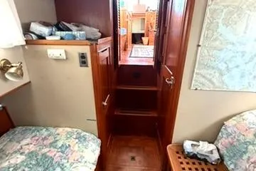 Slide: The Image of Interior of 1981 Grand Banks 36 Classic yacht, featuring cozy cabin with floral bedding. - 26