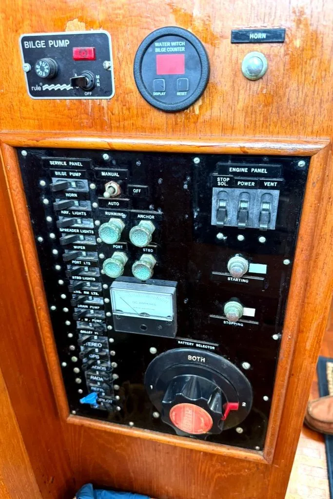 Slide: The Image of Control panel of a 1981 Grand Banks 36 Classic boat, featuring switches and gauges. - 29