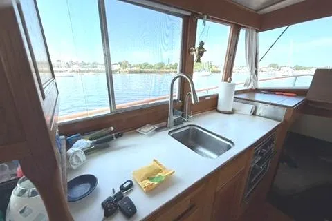 Slide: The Image of Interior of 1981 Grand Banks 36 Classic yacht kitchen with sink and scenic window view. - 30
