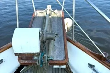 Slide: The Image of 1981 Grand Banks 36 Classic boat deck with railing and winch, on calm water. - 4