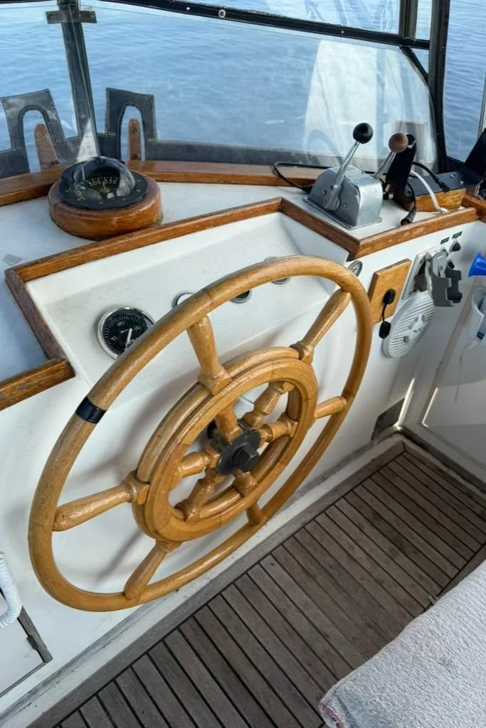 Slide: The Image of Wooden helm of 1981 Grand Banks 36 Classic boat with nautical instruments. - 5