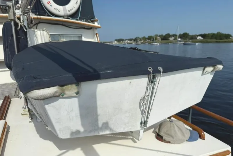 Slide: The Image of 1981 Grand Banks 36 Classic boat deck with covered equipment and scenic water view. - 8