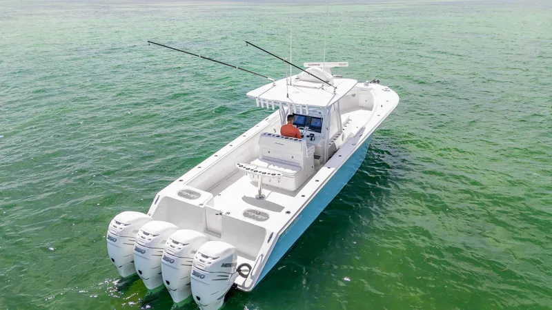 Slide: The Image of 2017 SeaHunter 39 Tournament boat with four engines on clear green water. - 1