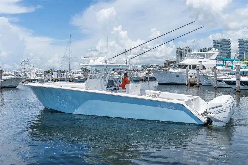 Slide: The Image of 2017 SeaHunter 39 Tournament boat docked in marina, featuring twin Mercury engines. - 10