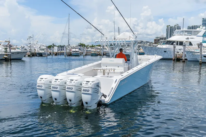 Slide: The Image of 2017 SeaHunter 39 Tournament boat with four engines docked in a marina. - 11