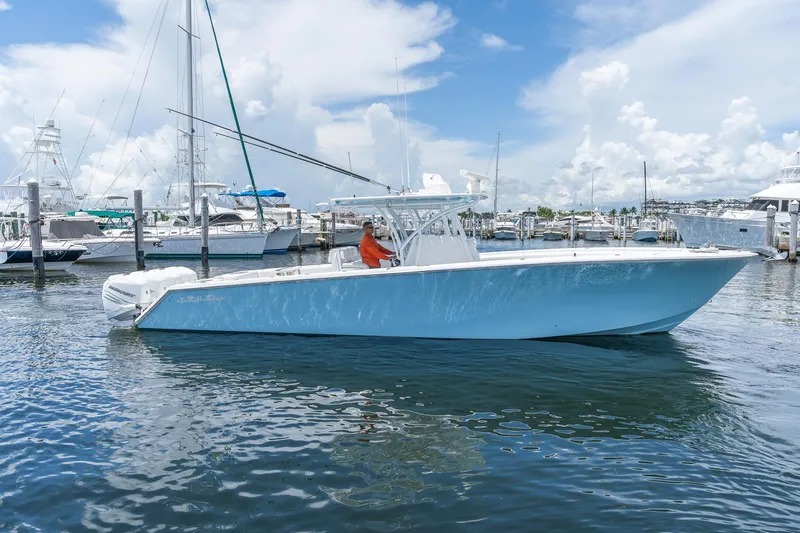 Slide: The Image of 2017 SeaHunter 39 Tournament boat docked in a marina under a blue sky. - 12