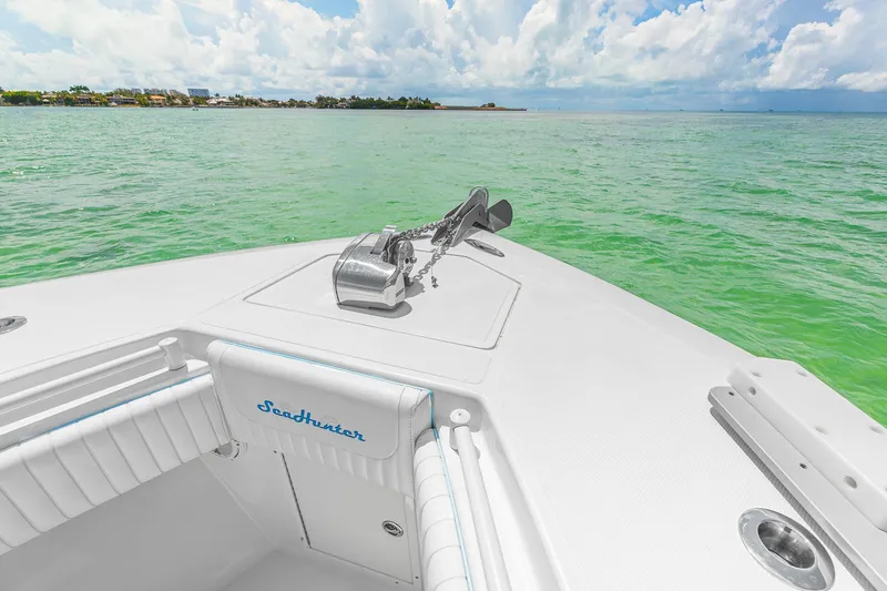 Slide: The Image of Bow of 2017 SeaHunter 39 Tournament boat on calm green water under cloudy sky. - 13