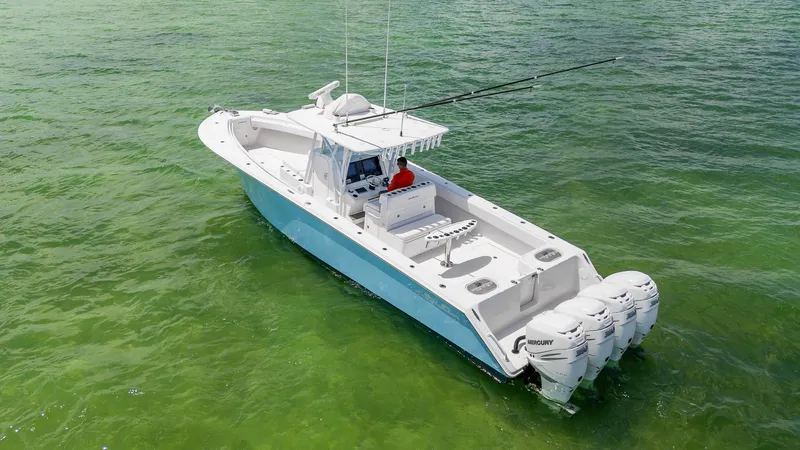 Slide: The Image of 2017 SeaHunter 39 Tournament boat on clear green water, equipped with multiple outboard engines. - 3