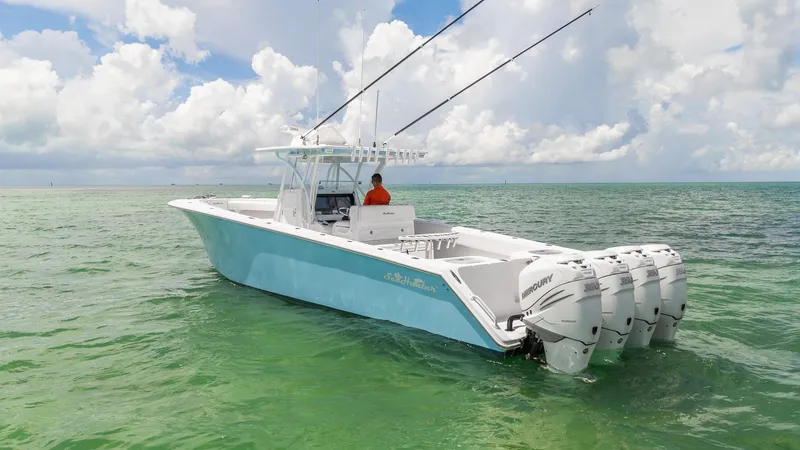 Slide: The Image of 2017 SeaHunter 39 Tournament boat with four engines on calm ocean waters. - 4