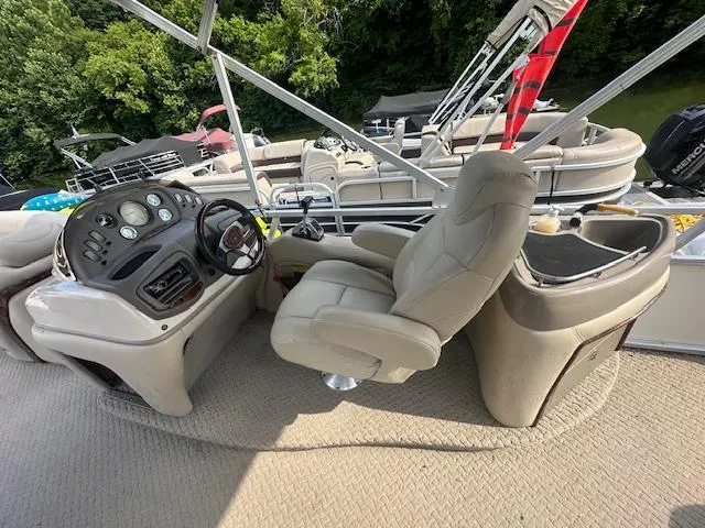 Slide: The Image of 2008 Sun Tracker PARTY BARGE 25 Regency Edition interior with captain's chair and control panel. - 2