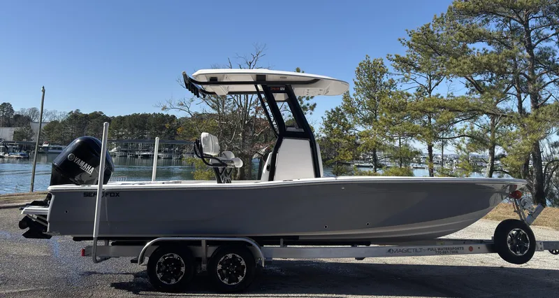 Slide: The Image of 2024 Sea Fox 251 Bay Fox boat on trailer by a scenic waterfront. - 4