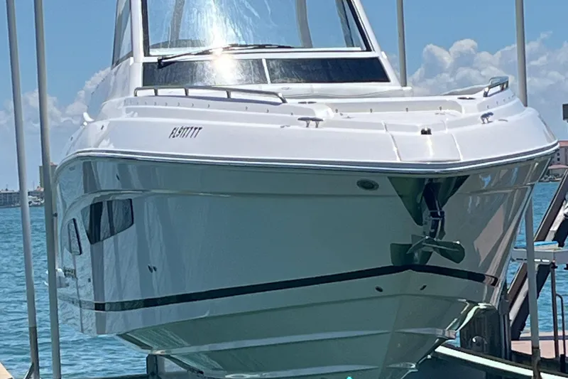 Slide: The Image of 2024 Regal 33 SAV boat on calm blue water under clear sky. - 3