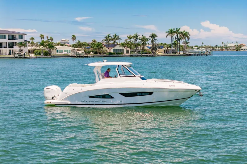 Slide: The Image of 2024 Regal 33 SAV boat deck with seating and twin Yamaha outboard engines. - 5