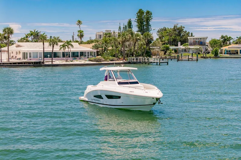 Slide: The Image of 2024 Regal 33 SAV boat interior with sink, grill, and storage compartments. - 7