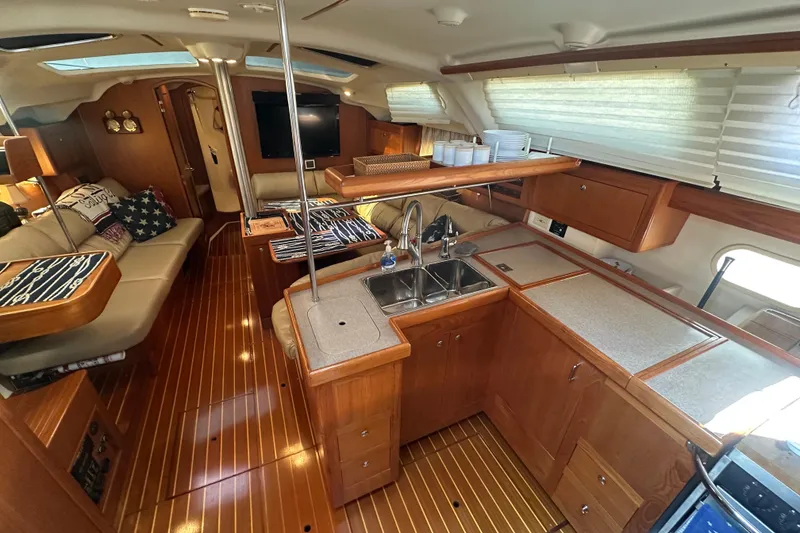 Slide: The Image of Luxurious interior of a 2002 Hunter 410 yacht with wood finishes and modern amenities. - 15
