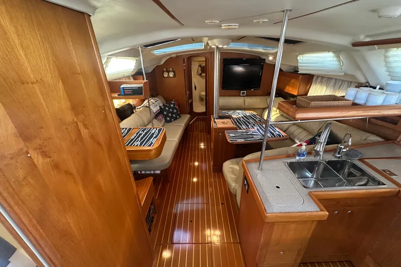 Slide: The Image of Luxurious 2002 Hunter 410 yacht interior with wood finish, cozy seating, and modern amenities. - 16