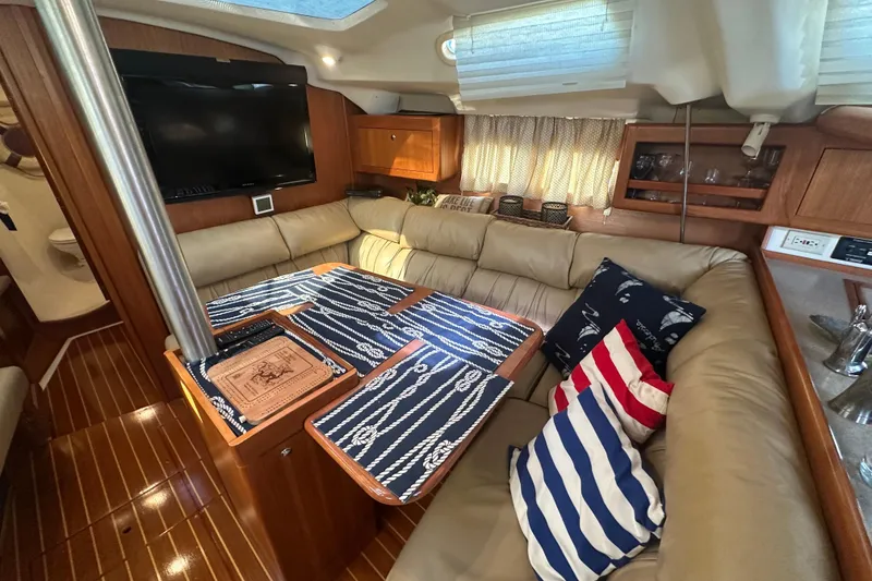 Slide: The Image of Luxurious interior of 2002 Hunter 410 yacht with cozy seating and nautical decor. - 19
