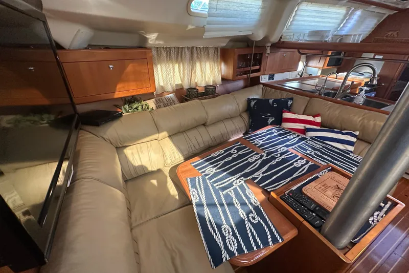 Slide: The Image of Luxurious interior of 2002 Hunter 410 yacht with cozy seating and nautical decor. - 20