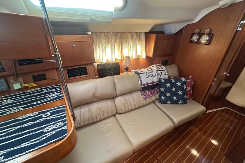 Slide: The Image of Interior of a 2002 Hunter 410 sailboat with cozy seating and nautical decor. - 22